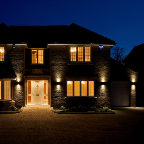 outdoor up down lights illuminated on exterior of house